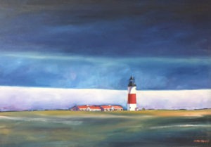 The iconic Sankaty Head Lighthouse with its red and white stripes stands on a grassy Nantucket landscape, framed by distant buildings. Above, the sky is dramatically painted in deep blue and gray, hinting at an approaching storm or twilight.