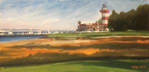 Painting of a lighthouse with red and white stripes near a coastline on Hilton Head Island. The foreground features grassy and sandy areas under a blue sky. A building sits adjacent to the lighthouse, with boats visible in the background near a dock in Harbour Town.