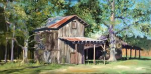 A rustic, weathered tobacco barn with a tin roof stands amidst tall trees in Cobbtown, GA. Sunlight filters through the leaves, casting dappled shadows on the grassy ground. The scene is vibrant, capturing a peaceful, rural setting with a vintage feel.