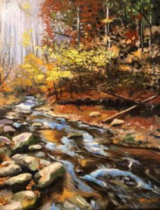 A painting of a serene autumn forest scene in the Smoky Mountain region features a flowing stream bordered by rocks. Trees with vibrant foliage in shades of yellow, orange, and red line the banks as sunlight gently filters through the leaves.