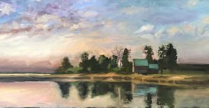 A serene lake reflects the sky with soft pastel hues. A small island with dense trees and two cabins is in the center, surrounded by calm water. The sky has a blend of pink, blue, and gray clouds creating a tranquil atmosphere.
