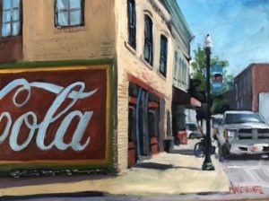 A street scene painting by Michael Meissner captures a vintage Coca-Cola mural on a brick building. Theres a sidewalk with a bike, a tree, and a parked white truck nearby under the clear blue sky.