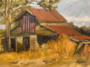 A rustic wooden barn with a rusted red metal roof, resembling the historic Dorn Mill, stands among tall, dry grass and trees under a cloudy sky. Partially covered by an American flag, the painting captures an autumnal rural scene.