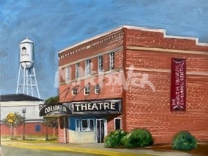 A painting of The Columbia Theatre captures entertainments essence, featuring its marquee and red banner. A water tower stands in the background under a bright blue sky, creating a vibrant scene on this sunlit day.