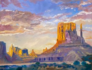This painting by Michael Meissner captures a desert landscape at sunset, showcasing prominent rock formations, colorful skies, and vibrant clouds. The rocky terrain is bathed in warm, golden light with deep shadows, creating a dramatic yet serene atmosphere.