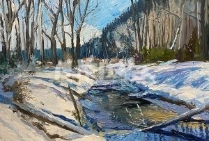 The Winter Creek painting captures a serene winter landscape with a snow-covered forest, leafless trees along a narrow reflective creek, all set against hill-dotted scenery beneath a clear blue sky.