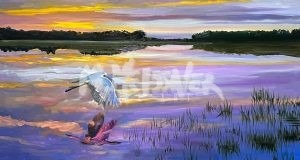 A calm evening emerges as a white bird glides over reflective waters at sunset, framed by a sky of orange, pink, and purple hues with glimpses of green marshland. The birds reflection ripples across the water, captured in Evening Flight.