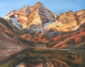 A painting in the style of Michael Meissner captures sunlit, rugged mountain peaks with pine trees at the base, all reflected in a calm lake. Warm light highlights orange, brown, and tan tones on the rocky slopes.