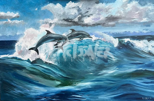 Two dolphins leap gracefully above a cresting ocean wave under a partly cloudy sky, with vibrant blue water and dynamic white foam capturing the energy of the sea.