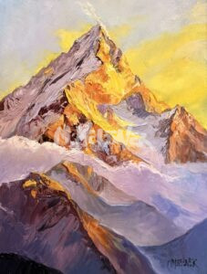 Snow-capped mountain peak glowing with orange and yellow light from a sunrise or sunset, set against a bright, cloudy sky.