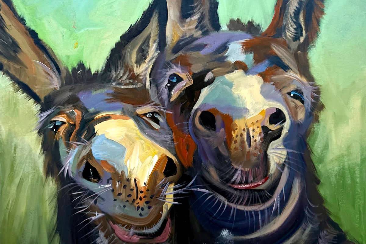 Colorful painting of two donkeys standing close together, facing the viewer with expressive faces and large ears, set against a soft green background.